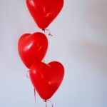 three red heart balloons